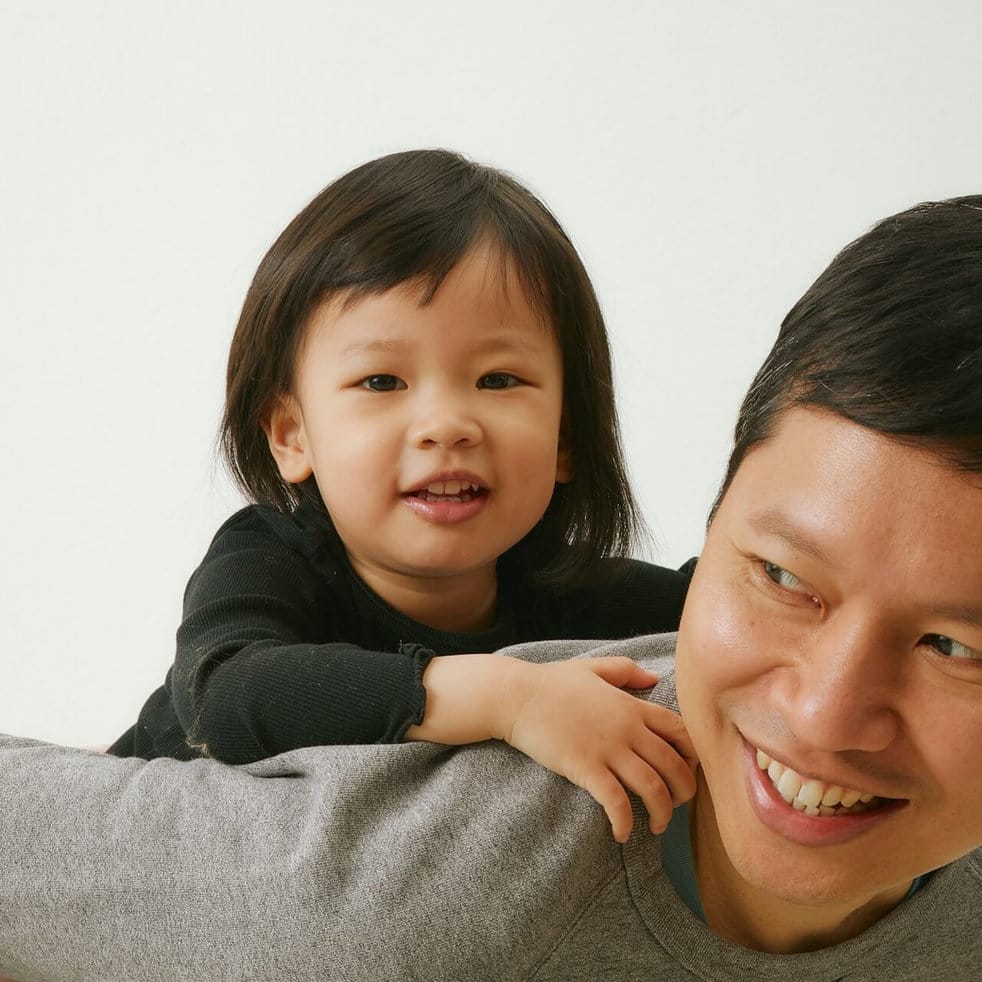 A parent and child laughing together