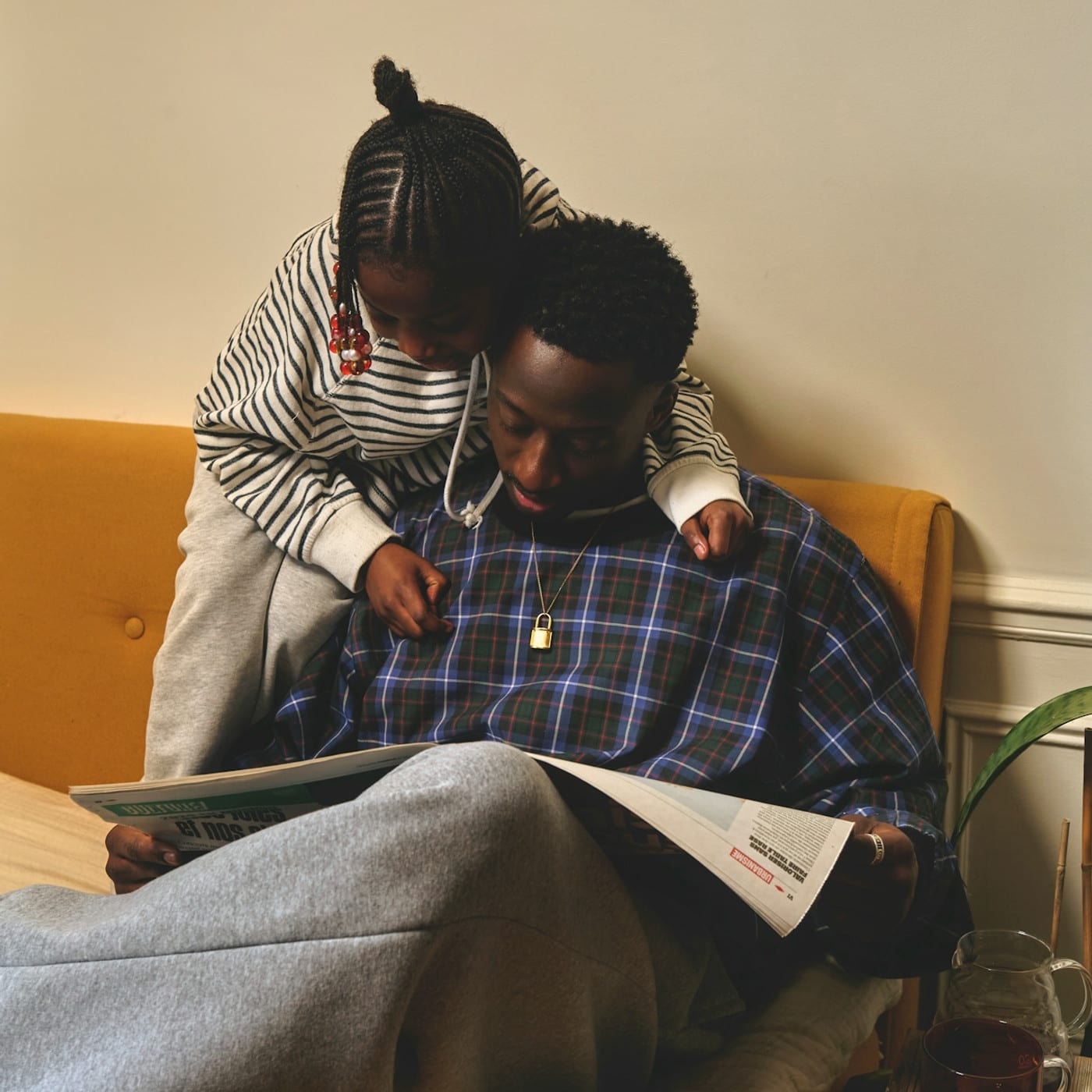 A dad reads a book about summer camp to his daughter to help support her transition to and from camp. He learned this strategy at Child Therapy Center LA.