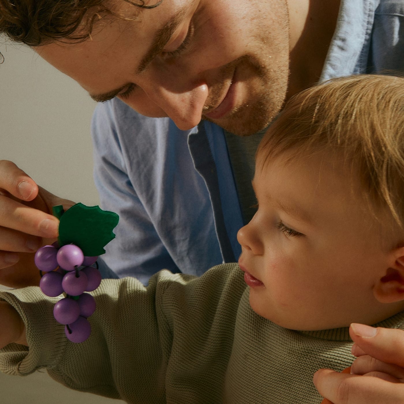 A father plays with his son after learning about practical strategies for managing toddler tantrums at play therapy in LA.
