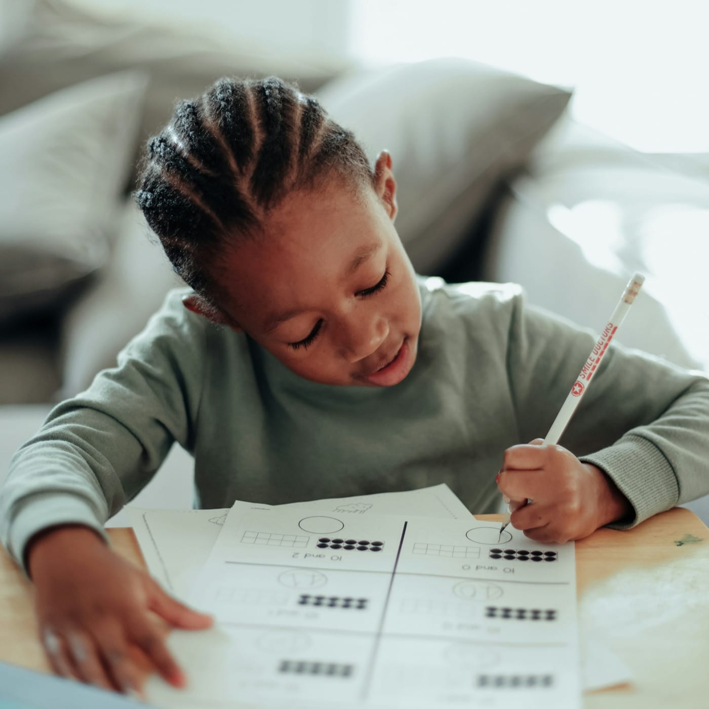 A child does his homework after a session of therapy in LA to help with his Pathological Demand Avoidance.
