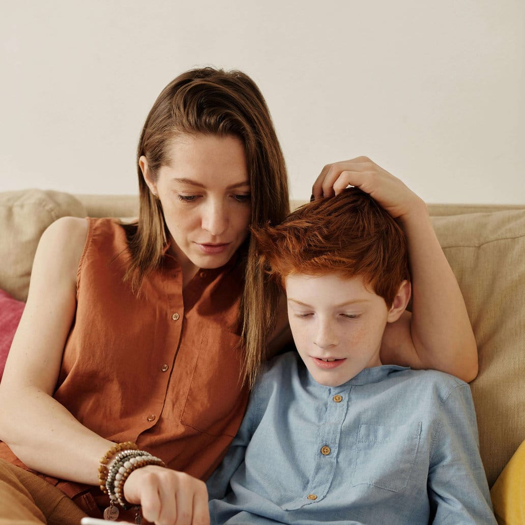 A parent reading with her son