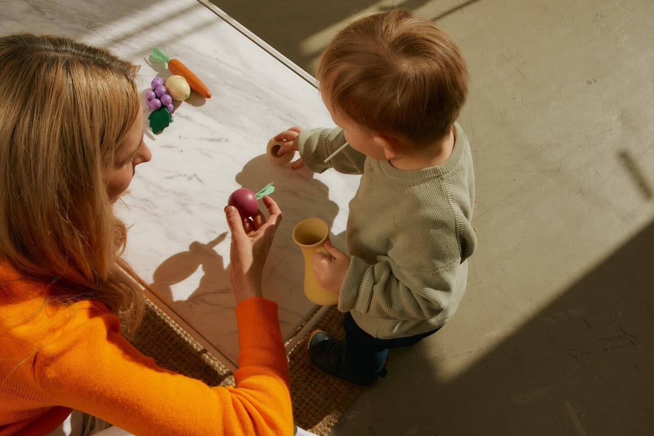 A therapist helps their child client with behavioral issues