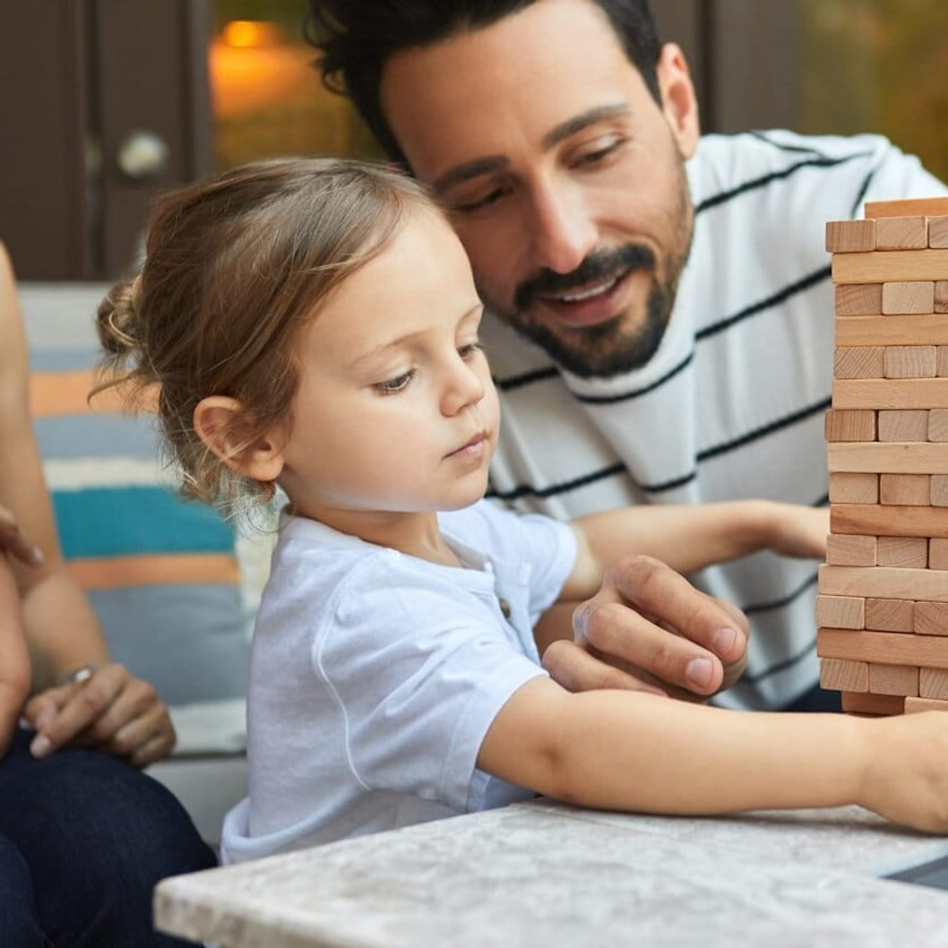 A father and daughter building with blocks