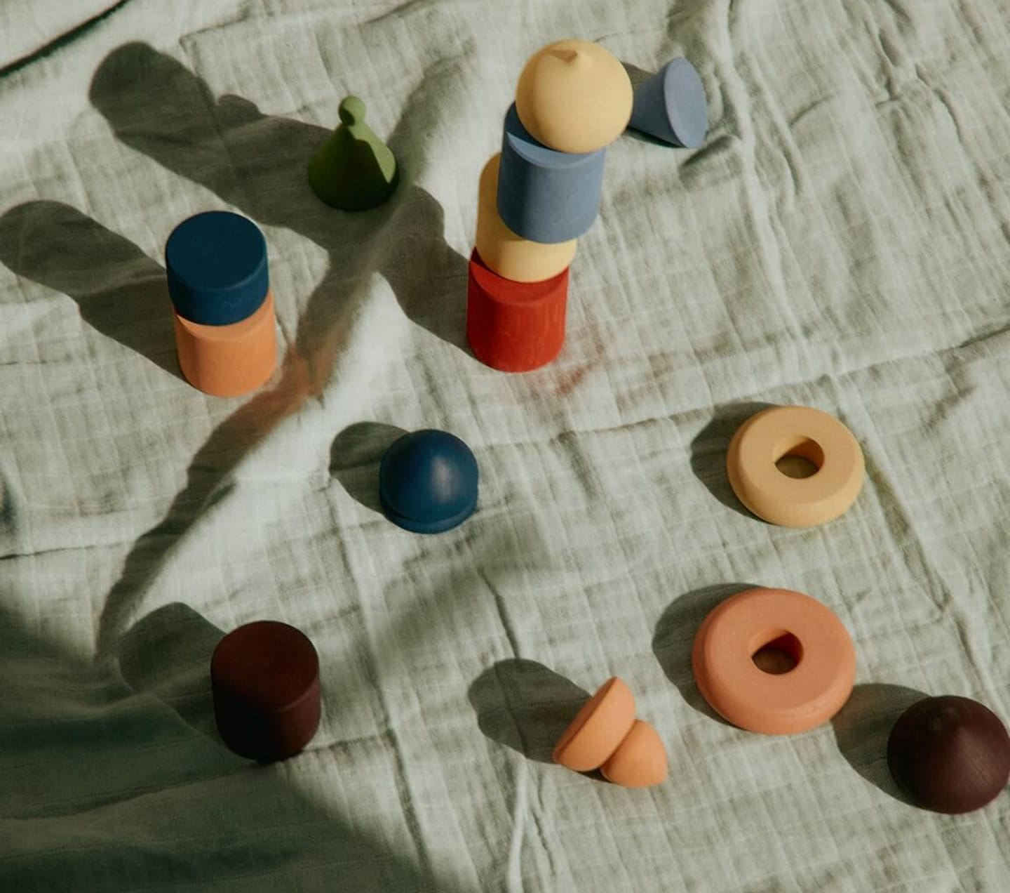 Wooden toys on a linen blanket